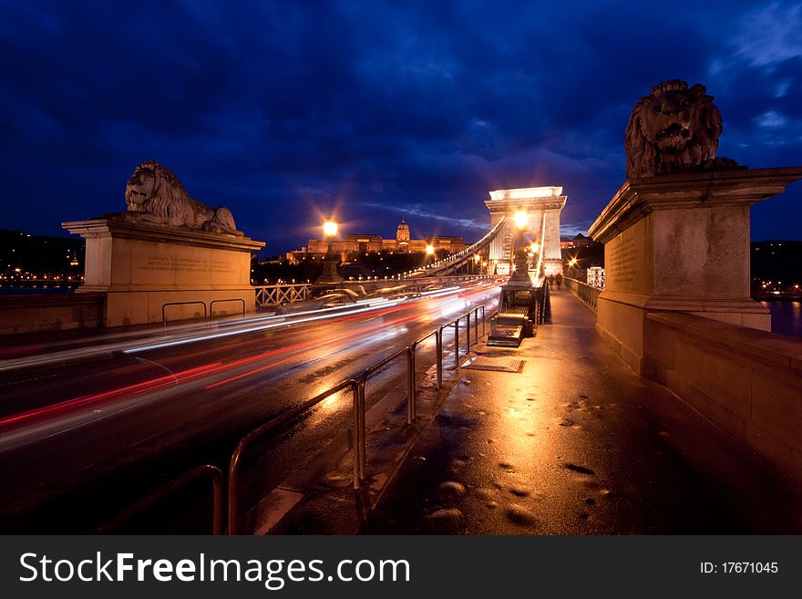 Budapest by night / Chain Bridge with traffic and with Buda castle background