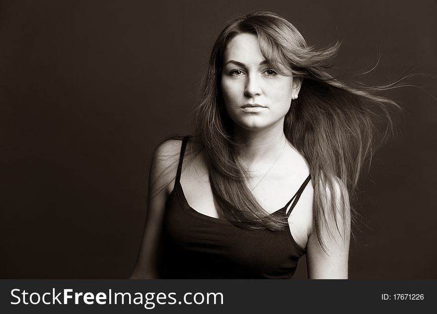 Attractive red woman with uncurl hairs against brown background