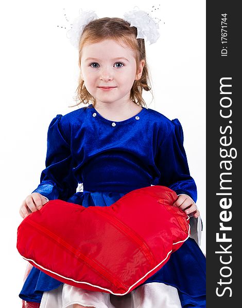 Beautiful girl sitting holding a red heart. Beautiful girl sitting holding a red heart