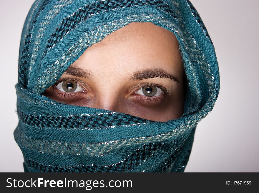 Portrait of charming European woman with shawl. Artistic selective focus on eyes. Portrait of charming European woman with shawl. Artistic selective focus on eyes.