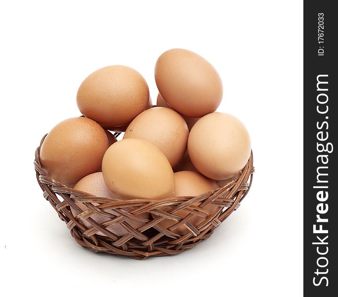 Eggs in the basket isolated on white background