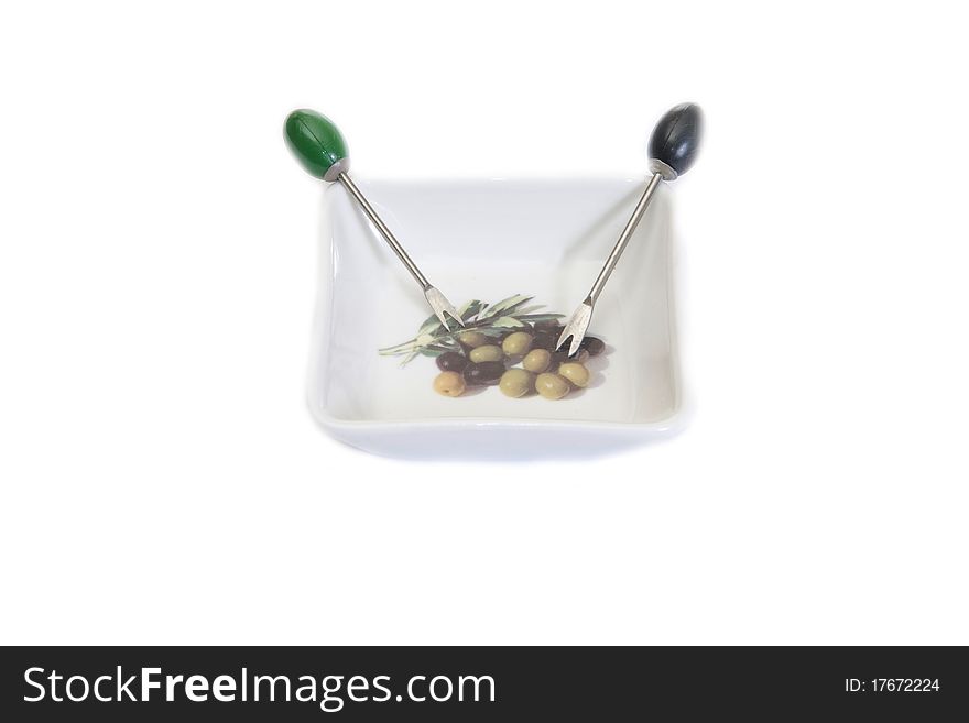 White plate for olives and plugs for berries, on a white background