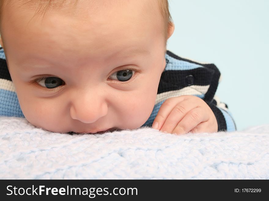 Two month old baby boy lying on his stomach