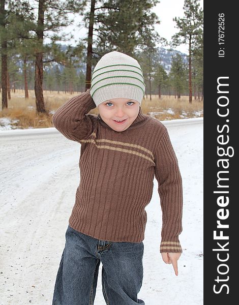 Warmly dressed boy playing outside in the snow. Warmly dressed boy playing outside in the snow