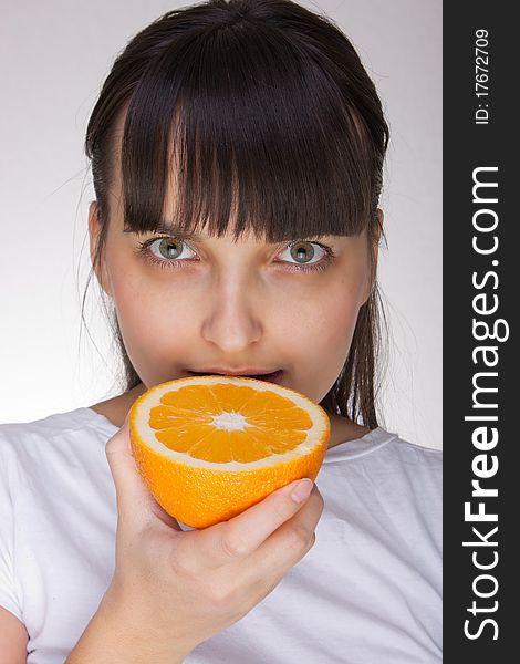Attractive caucasion girl with orange in hands. Attractive caucasion girl with orange in hands