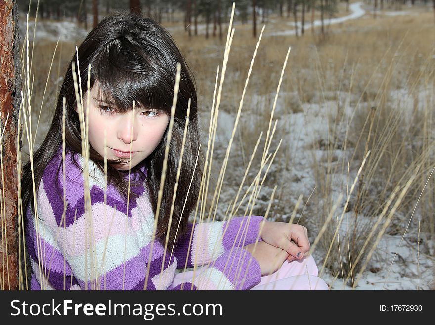 Young brunette teen playing in the field after the snowfall. Young brunette teen playing in the field after the snowfall