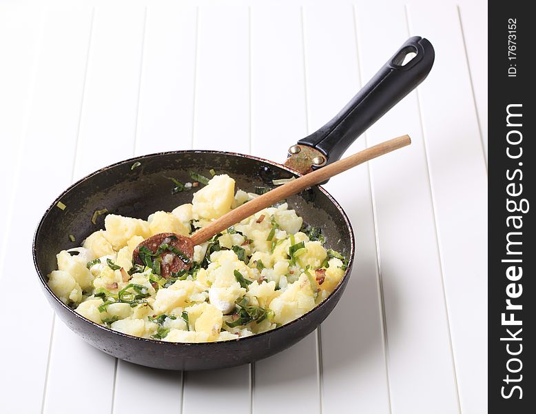 Crushed potatoes stir fried with spring onion and garlic. Crushed potatoes stir fried with spring onion and garlic