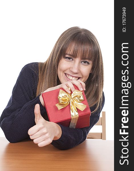 Smiling woman holding a red box and making thumb up. Smiling woman holding a red box and making thumb up