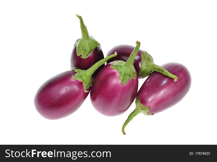 Purple Eggplants Arranged On A White Background