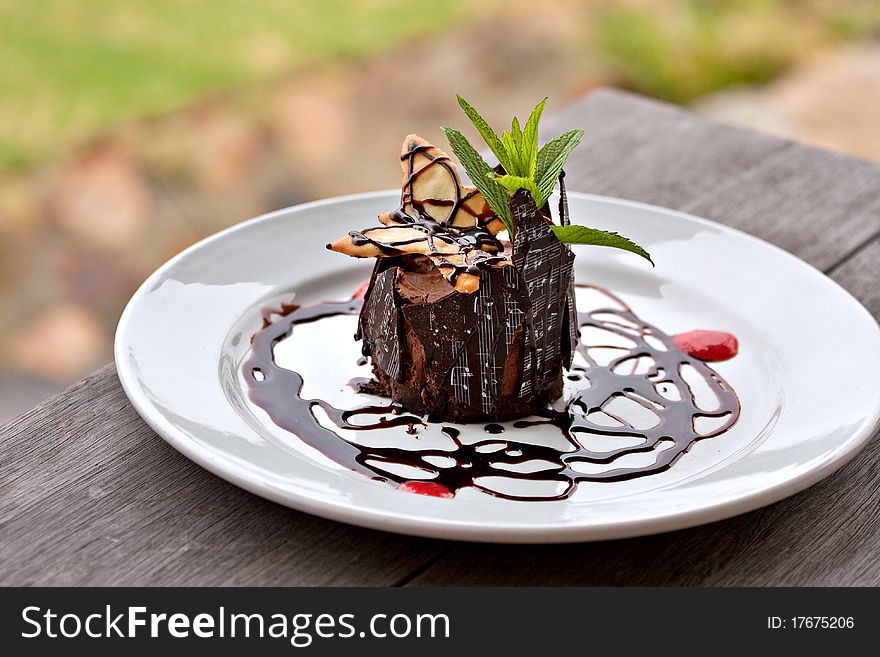 Beautifully decorated chocolate mousse served on  white plate with chocolate shards printed with musical notes. Beautifully decorated chocolate mousse served on  white plate with chocolate shards printed with musical notes