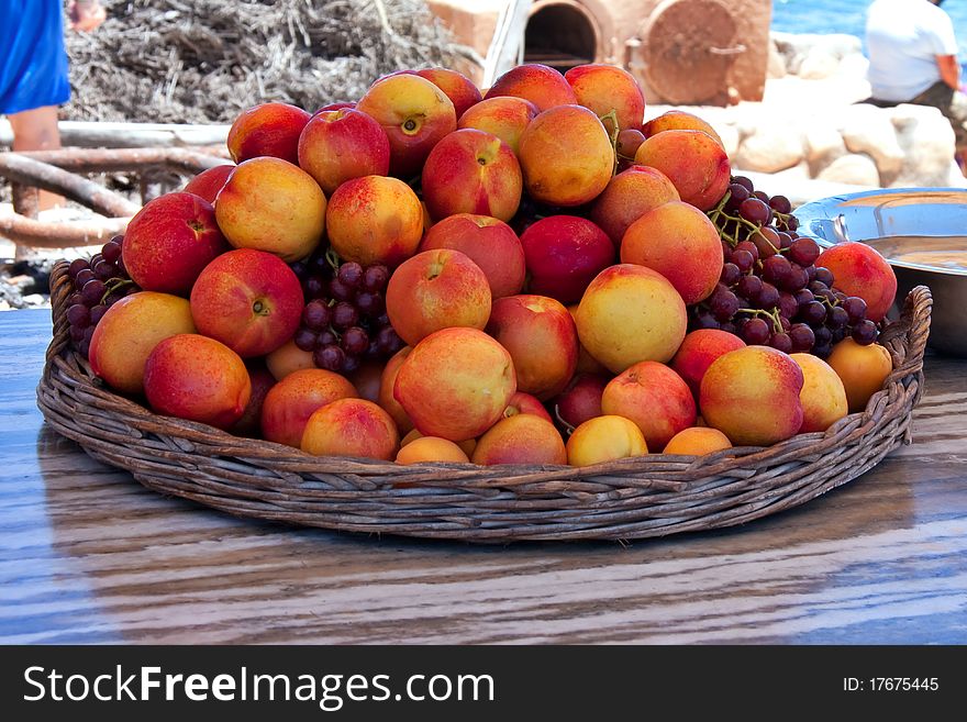 Large basket of peaches and grapes served at outdoor restaurant on the coast on westcoast of south africa, Lamberts Bay. Large basket of peaches and grapes served at outdoor restaurant on the coast on westcoast of south africa, Lamberts Bay