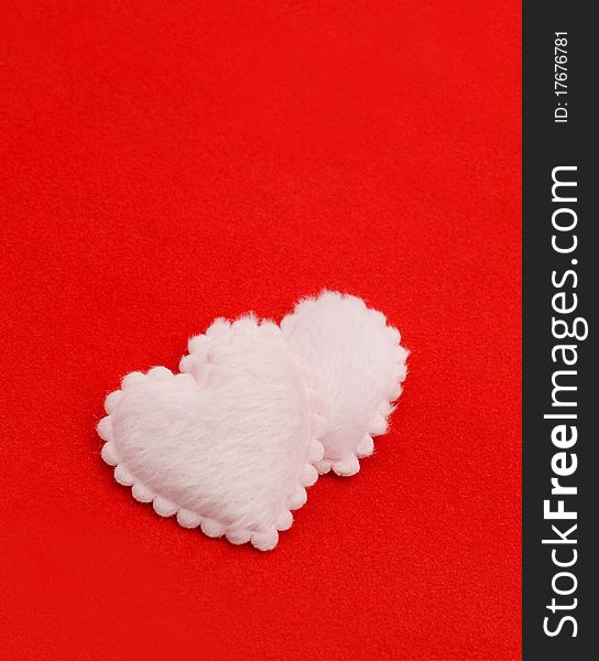 Two fluffy hearts on a red background