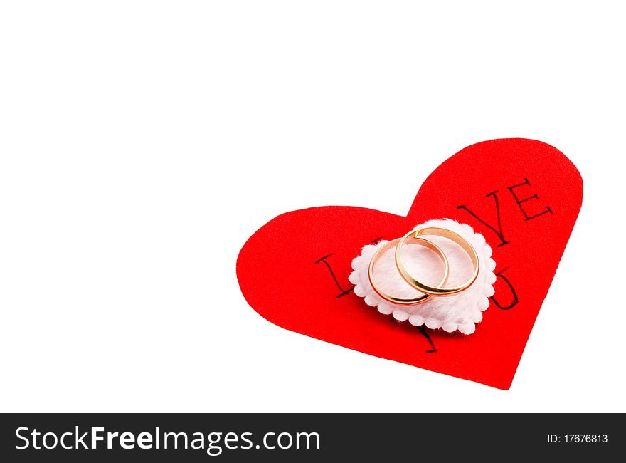 Wedding rings on the heart, white background
