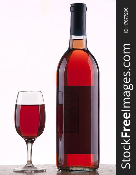 Glass and bottle of rose wine with white background