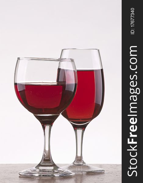 Two different glass of rose wine  with gray background