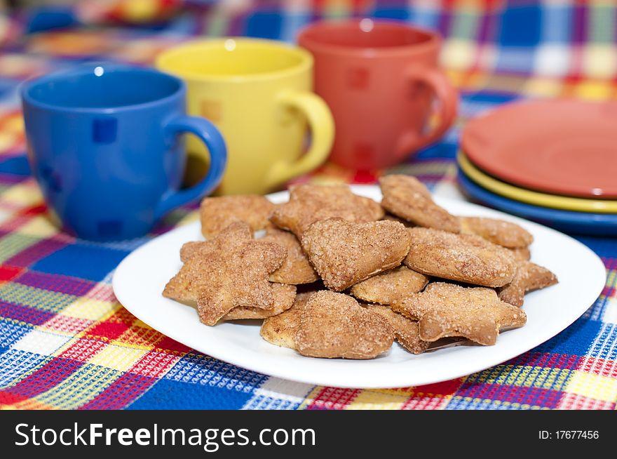 Cookies on a plate with three cups and saucers. Cookies on a plate with three cups and saucers