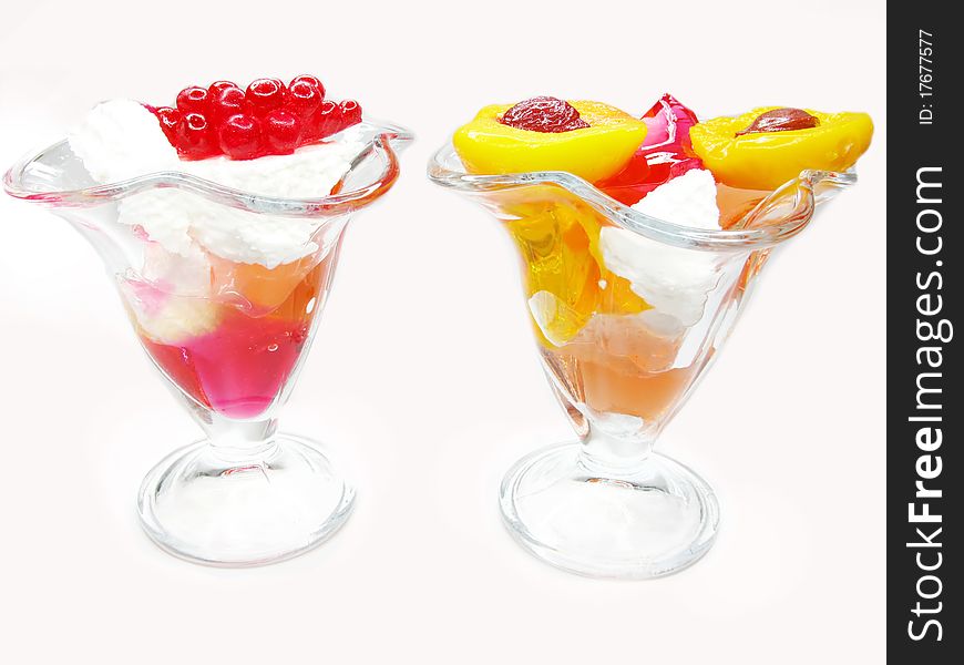 Two desserts with dairy pudding and jelly fruits