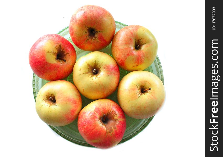 Fresh apples on the green plate isolated on white. Fresh apples on the green plate isolated on white