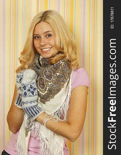 Close-up of an beautiful young Russian woman in mild winter mittens and a scarf. Happy. Close-up of an beautiful young Russian woman in mild winter mittens and a scarf. Happy