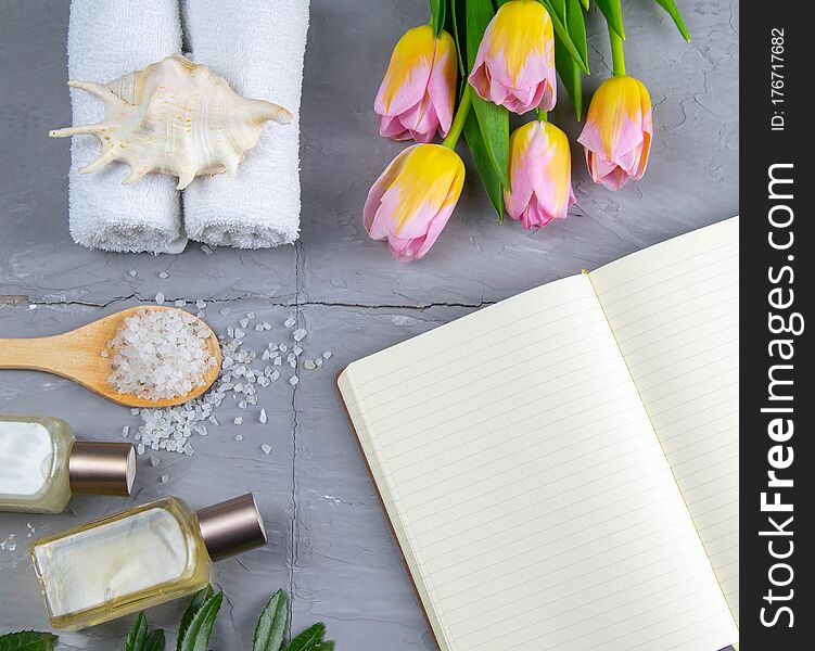 Spa with natural olive soap, tulips and sea salt and an open notebook for writing