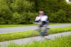 Blurred Man Riding Bicycles Along A Country Road Royalty Free Stock Photos Blurred Man Riding Bicycles Along A Country Road Royalty Free Stock Photos
