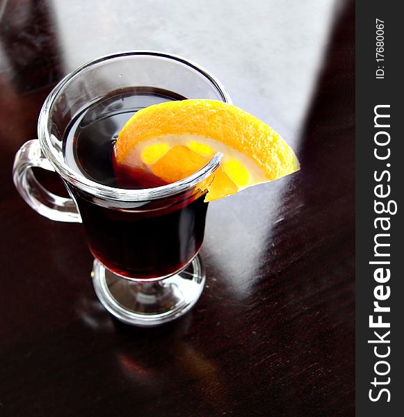 The photography of mulled wine with orange and spices.