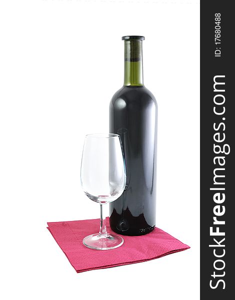 Bottle of red wine and an empty glass on the serviette isolated on white. Bottle of red wine and an empty glass on the serviette isolated on white