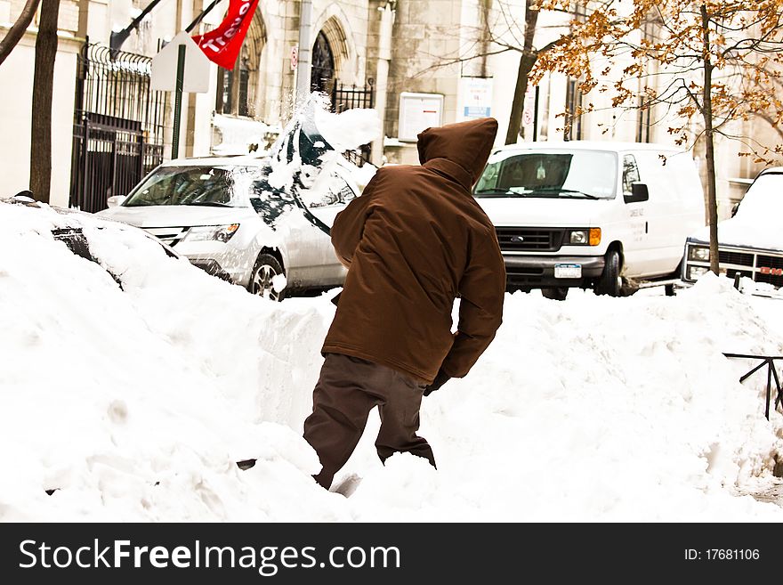 This is an image of a man clearing snow from his car. This is an image of a man clearing snow from his car.
