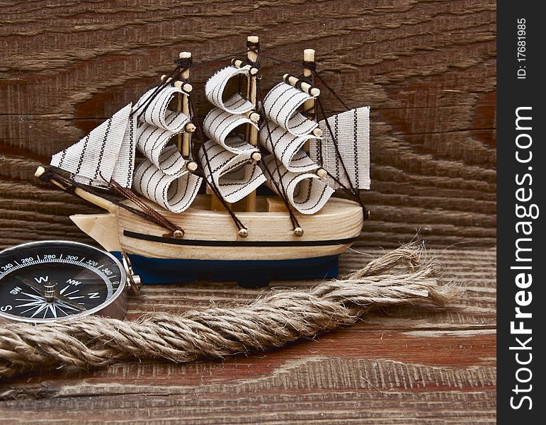Compass, rope and model classic boat