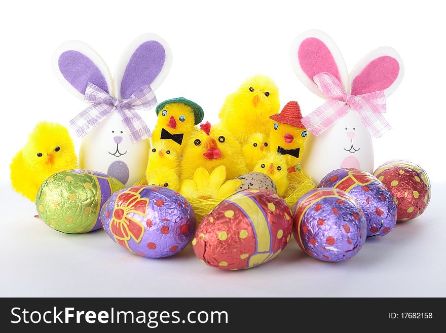 Easter Bunnies And Chicks With Eggs Over White