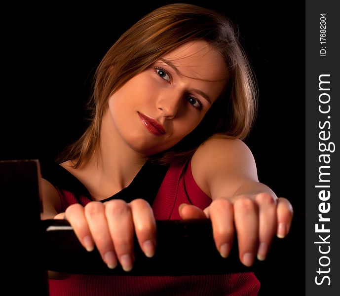 Pretty young girl sitting on chair