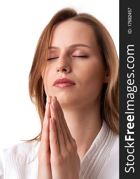 Young Woman Sitting With Pray Gesture And Eyes Clo