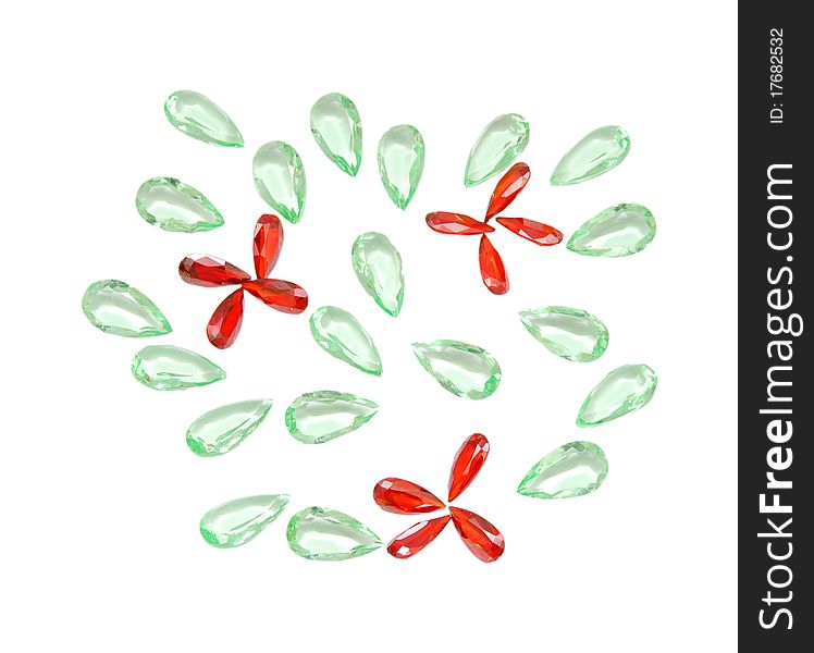 Glass and plastic bright red-green carat costume jewellery on a street market table. Good for background. Glass and plastic bright red-green carat costume jewellery on a street market table. Good for background.