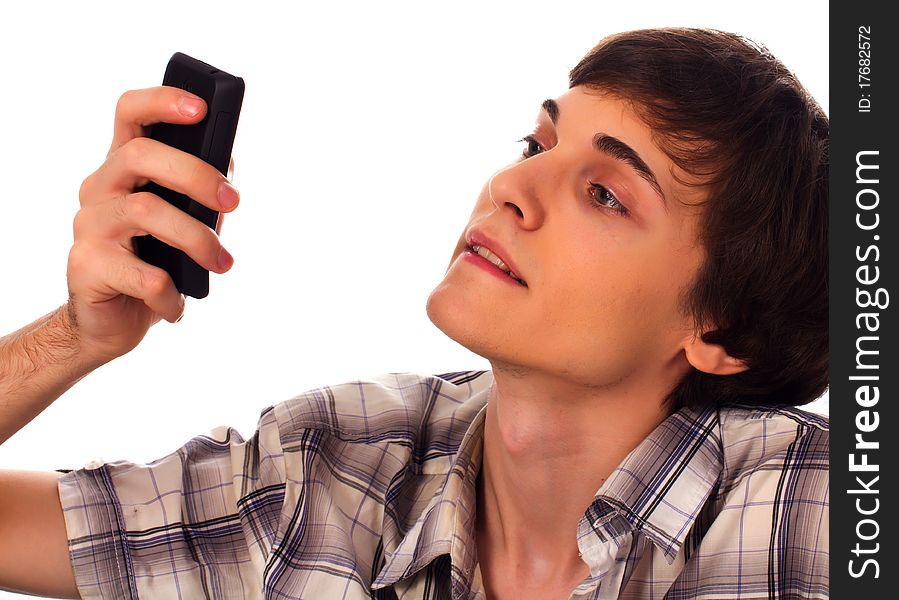 Young man types sms holding phone in hands on white background