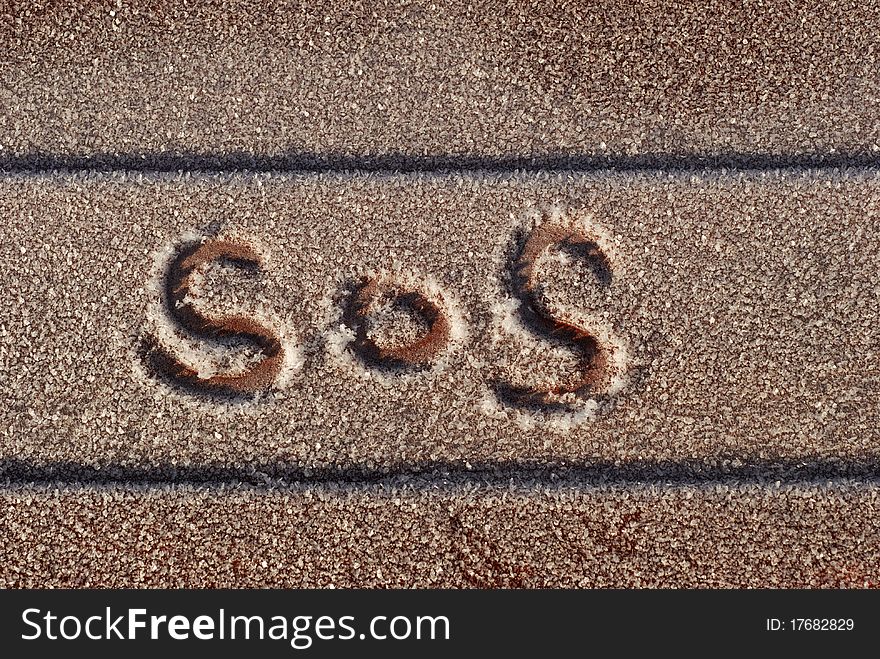 S.O.S written on a boat outdoors in ice with a finger. S.O.S written on a boat outdoors in ice with a finger.