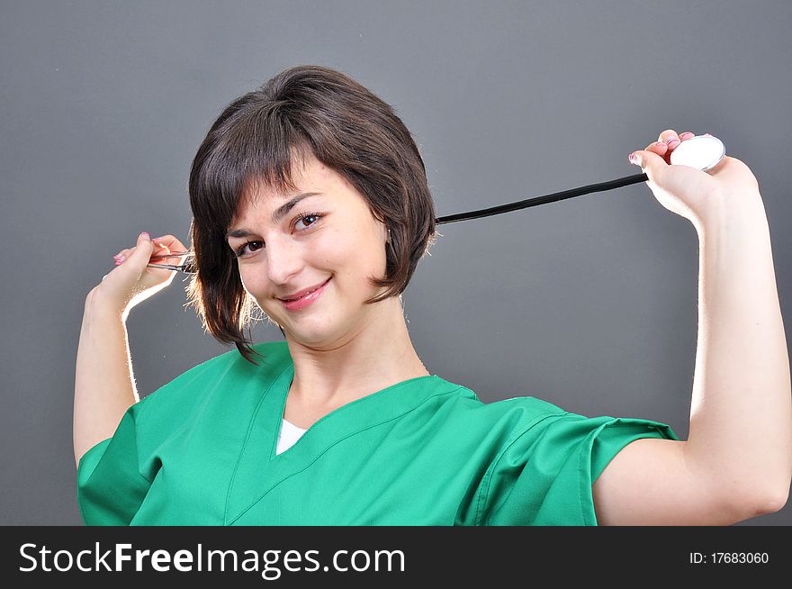 Attractive lady doctor on a over gray background