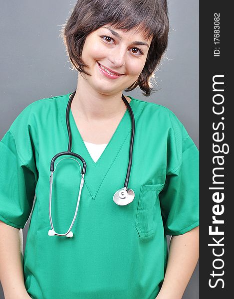 Attractive lady doctor on a over gray background