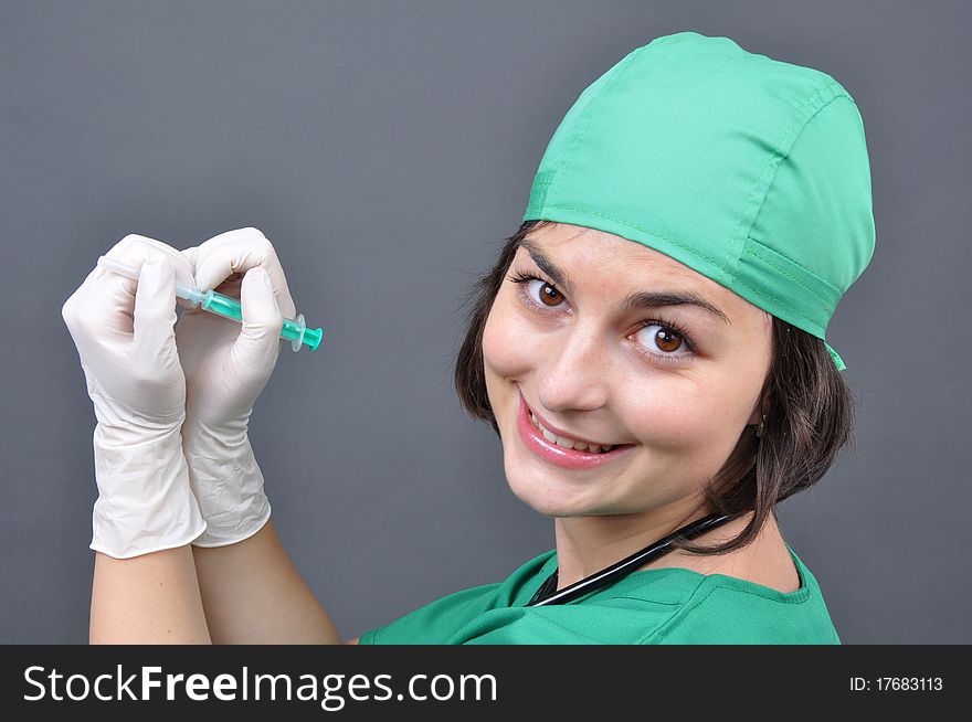 Attractive lady doctor on a over gray background