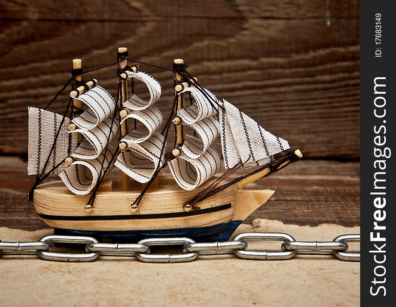 Model ship on wood background