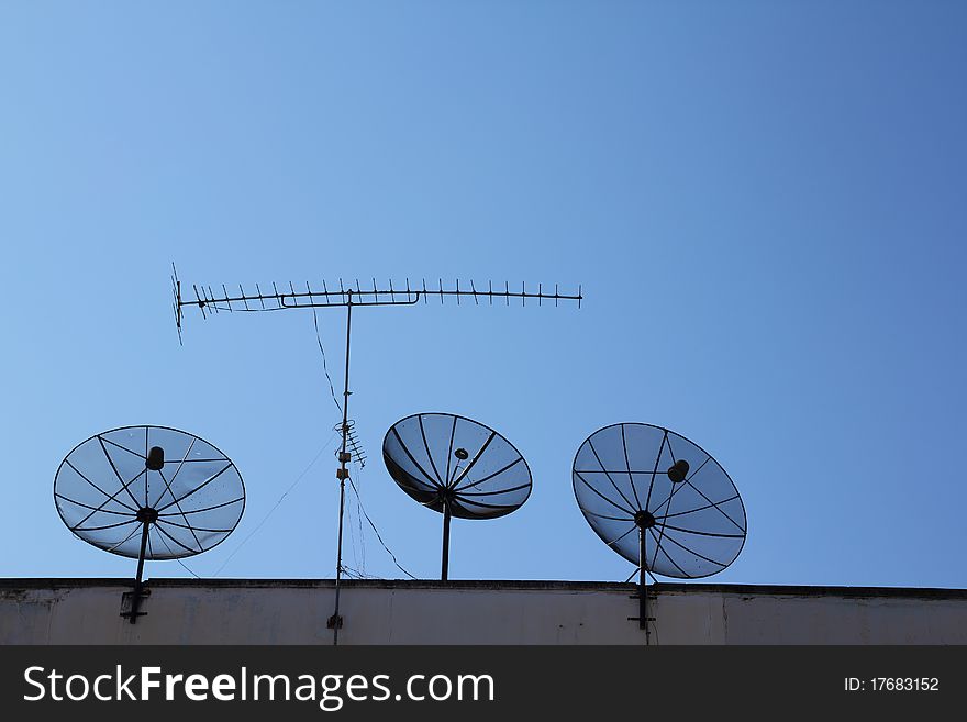 Satellite dish on blue sky background