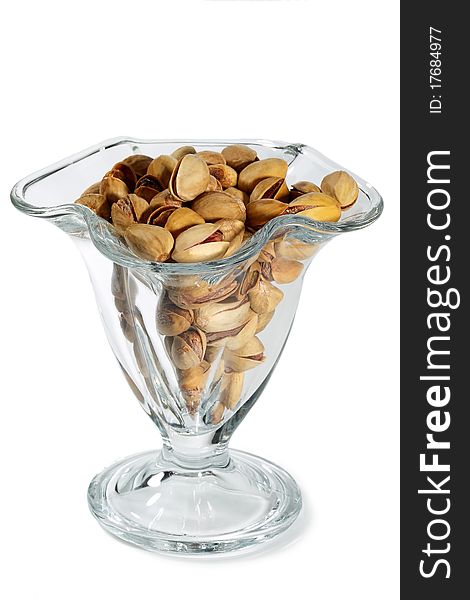 Pistachio nuts and salt in a glass vase isolated on white background