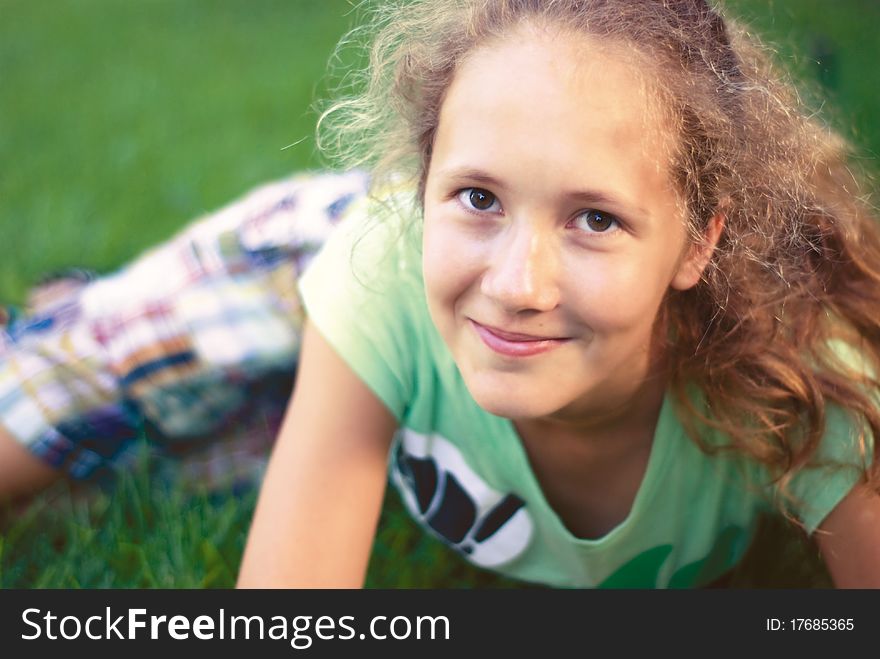 A young girl on green grass