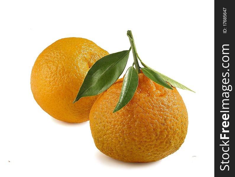 Two tangerines with green leaf on the white background