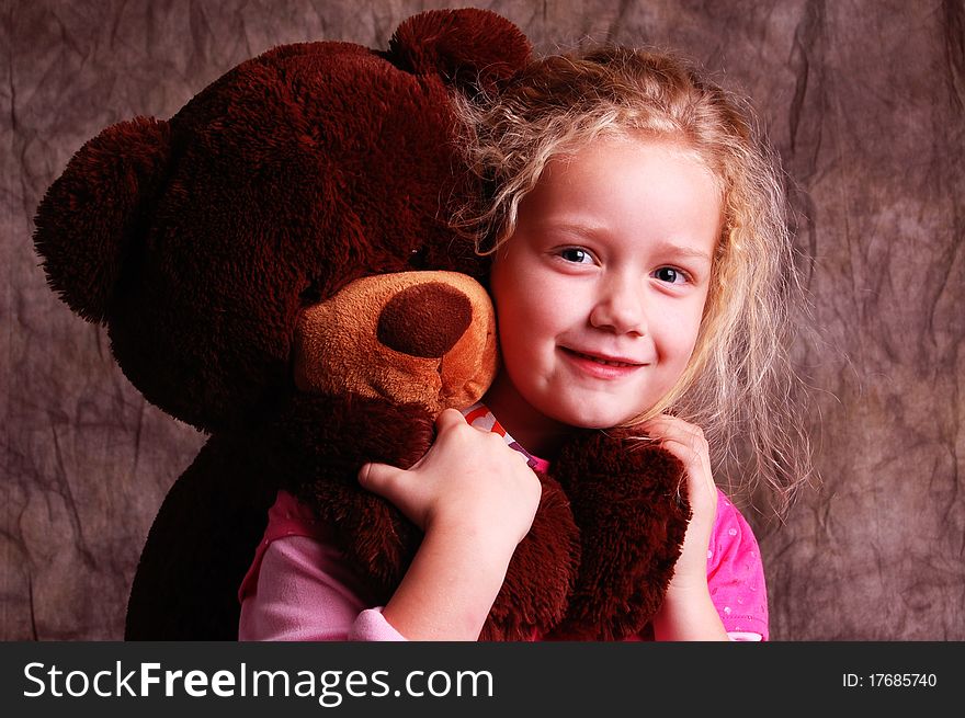 A child playing with her favorite stuffed bear. A child playing with her favorite stuffed bear