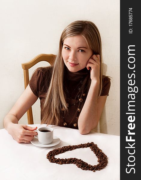 Beautiful girl drinking coffee, the heart of the coffee beans, Valentine's Day