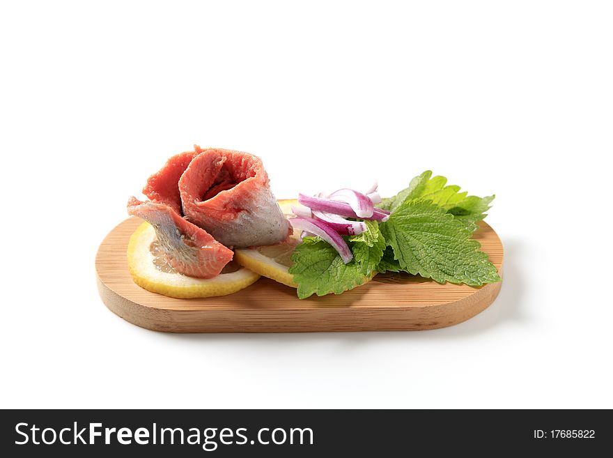 Matjes herring fillet with slices of lemon and onion. Matjes herring fillet with slices of lemon and onion