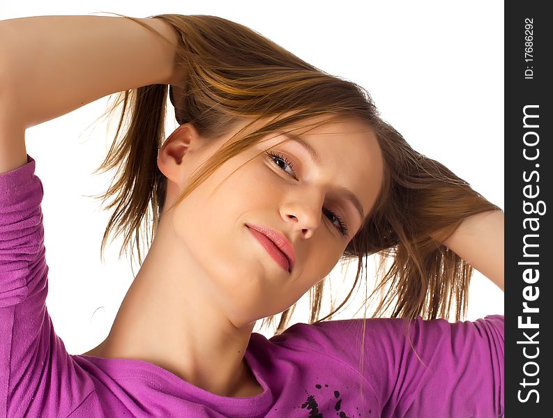 Pretty young female playing with her hair on white background