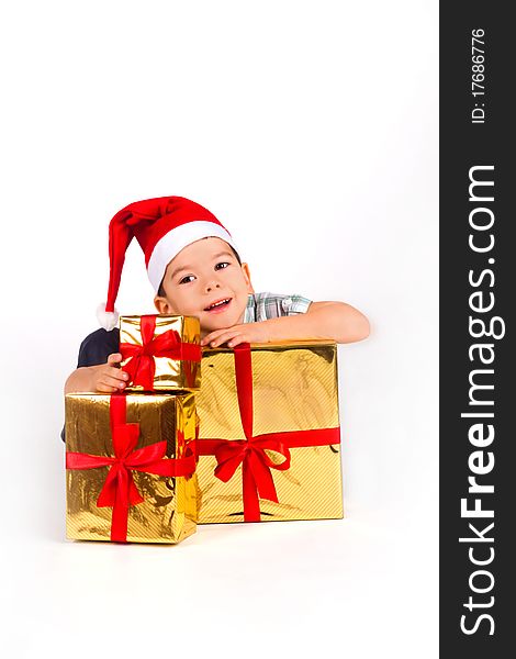 Little Boy In Santa Hat With A Bunch Of Gifts