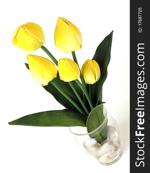 Yellow tulips flowers inside a glass vase