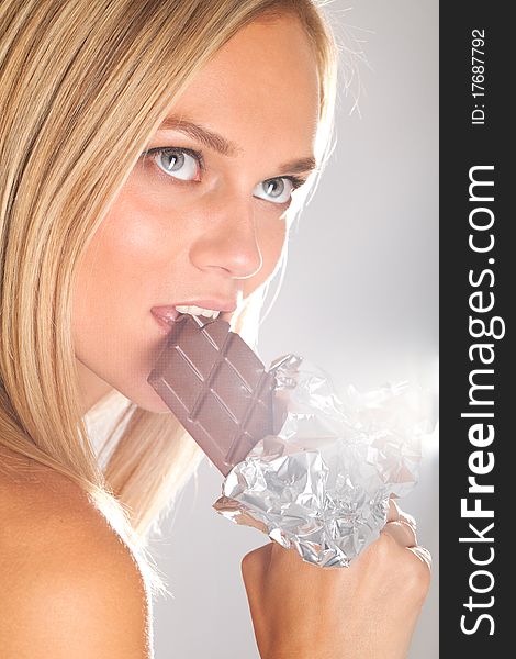 Sexy woman eating chocolate